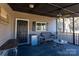 Screened porch with ceiling fan and outdoor furniture at 247 Camp Rotary Rd, Gastonia, NC 28052