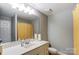 Clean bathroom featuring a single vanity, ample lighting, and neutral-colored walls at 300 W 5Th St # 339, Charlotte, NC 28202