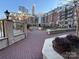 Exterior of buildings surrounding community courtyard with manicured trees and pavers at 300 W 5Th St # 339, Charlotte, NC 28202