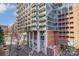 Modern high-rise building featuring balconies and large glass windows and red brick at 300 W 5Th St # 339, Charlotte, NC 28202