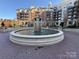 A large fountain surrounded by brick pavers and well-manicured landscaping at 300 W 5Th St # 339, Charlotte, NC 28202