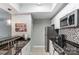 Kitchen area with stainless steel appliances, dark granite counters, and tiled backsplash at 300 W 5Th St # 339, Charlotte, NC 28202