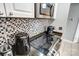 Kitchen close up with stainless steel appliances, dark countertops, and tile backsplash at 300 W 5Th St # 339, Charlotte, NC 28202