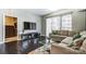 Comfortable living room with hardwood floors, large windows, and a modern entertainment center at 300 W 5Th St # 339, Charlotte, NC 28202