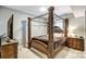 Spacious main bedroom featuring an ornate four-poster bed and ample natural light at 300 W 5Th St # 339, Charlotte, NC 28202