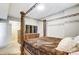 Elegant main bedroom featuring an ornate four-poster bed, hardwood floors, and ample natural light at 300 W 5Th St # 339, Charlotte, NC 28202