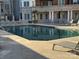 Community pool area featuring lounge chairs and lush landscaping at 300 W 5Th St # 339, Charlotte, NC 28202