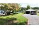 Landscaped backyard with detached garage and driveway at 315 9Th Sw St, Conover, NC 28613