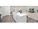 A bright kitchen with a white island, stainless steel sink, and stylish breakfast bar at 384 Bly St, Rock Hill, SC 29732