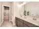 Double vanity bathroom with gray cabinets and a view into the shower at 4008 Pinot Way, Indian Land, SC 29707