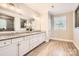 Elegant bathroom with double vanity, granite counters, and large mirror at 4008 Pinot Way, Indian Land, SC 29707