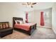 Cozy bedroom with plush carpeting, large windows, and ceiling fan at 4008 Pinot Way, Indian Land, SC 29707