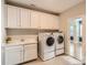 Bright laundry room with white cabinets and washer/dryer included at 4008 Pinot Way, Indian Land, SC 29707