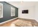 Living room with hardwood floors, neutral walls, and a jute rug at 4008 Pinot Way, Indian Land, SC 29707