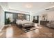 Virtually staged main bedroom with a king-size bed and sitting area at 4008 Pinot Way, Indian Land, SC 29707