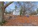 Spacious backyard with playset, fire pit, and a large tree at 511 E Church St, Kershaw, SC 29067