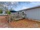 Wooden deck with stairs, umbrella, and partial view of home at 511 E Church St, Kershaw, SC 29067