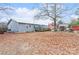 Large backyard with leaf covered ground and a view of the home at 511 E Church St, Kershaw, SC 29067