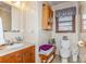 Simple bathroom with toilet, vanity, and window for natural light at 511 E Church St, Kershaw, SC 29067