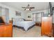 Spacious bedroom with a king-size bed, dresser, and ceiling fan at 511 E Church St, Kershaw, SC 29067