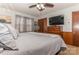 Spacious bedroom with a king-size bed, dresser, and ceiling fan at 511 E Church St, Kershaw, SC 29067