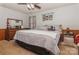 Spacious bedroom with a king-size bed, dresser, and ceiling fan at 511 E Church St, Kershaw, SC 29067