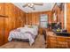 Cozy bedroom with wood paneling, a double bed, and a workspace at 511 E Church St, Kershaw, SC 29067