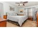 Spacious bedroom with a king-size bed, dresser, and ceiling fan at 511 E Church St, Kershaw, SC 29067