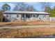 Ranch style home with gray siding, metal roof, and a covered porch at 511 E Church St, Kershaw, SC 29067