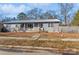 Gray ranch home with metal roof, front porch, and fenced backyard at 511 E Church St, Kershaw, SC 29067