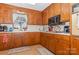 Kitchen with wood cabinets, microwave, and an electric oven at 511 E Church St, Kershaw, SC 29067