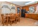 Kitchen with wood cabinets, round dining table, and built-in microwave at 511 E Church St, Kershaw, SC 29067