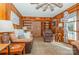 Living room with wood paneling, built-in shelving, and a ceiling fan at 511 E Church St, Kershaw, SC 29067