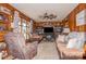 Living room with wood paneling, ceiling fan, and comfortable seating at 511 E Church St, Kershaw, SC 29067