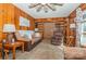 Living room with wood paneling, built-in shelving, and a ceiling fan at 511 E Church St, Kershaw, SC 29067