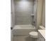 Bathroom with a bathtub, toilet and gray tile surround at 605 Nesbe St # 2228, Lancaster, SC 29720