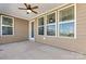 Covered back patio with ceiling fan and multiple windows at 9023 Daring Ct, Charlotte, NC 28215