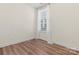 Simple bedroom with hardwood floors and large window at 9023 Daring Ct, Charlotte, NC 28215