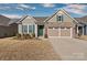 Tan brick ranch home with 2-car garage and green front door at 9023 Daring Ct, Charlotte, NC 28215