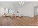 Large living room with hardwood floors and access to balcony at 9023 Daring Ct, Charlotte, NC 28215