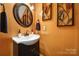 Small bathroom with dark vanity, white sink, and decorative wall art at 9450 Shumacher Nw Ave, Concord, NC 28027