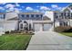 Brick front townhouse with double garage and landscaping at 9450 Shumacher Nw Ave, Concord, NC 28027