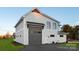 Exterior view of a detached garage with gray doors at 104 Isle Of Pines Rd, Mooresville, NC 28117