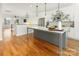 Modern kitchen with island, white cabinets, and hardwood floors at 104 Isle Of Pines Rd, Mooresville, NC 28117