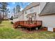 A tan home featuring a wood deck with railings and a table with chairs at 105 Whimbrel Ln, Mooresville, NC 28117
