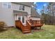 A tan home featuring a wood deck with railings and a table with chairs at 105 Whimbrel Ln, Mooresville, NC 28117