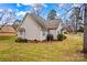 A home's backyard that features grass, partial siding, and a small brick building at 105 Whimbrel Ln, Mooresville, NC 28117