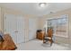 This is a carpeted bedroom with a small table, two doors, one window and a rocking chair at 105 Whimbrel Ln, Mooresville, NC 28117