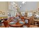 Dining area adjacent to living area with hardwood floors, chandelier, and open floor plan at 105 Whimbrel Ln, Mooresville, NC 28117