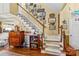 Charming foyer featuring hardwood floors, staircase, and decorative wall accents at 105 Whimbrel Ln, Mooresville, NC 28117
